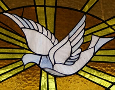 Stained glass window depicting a white dove